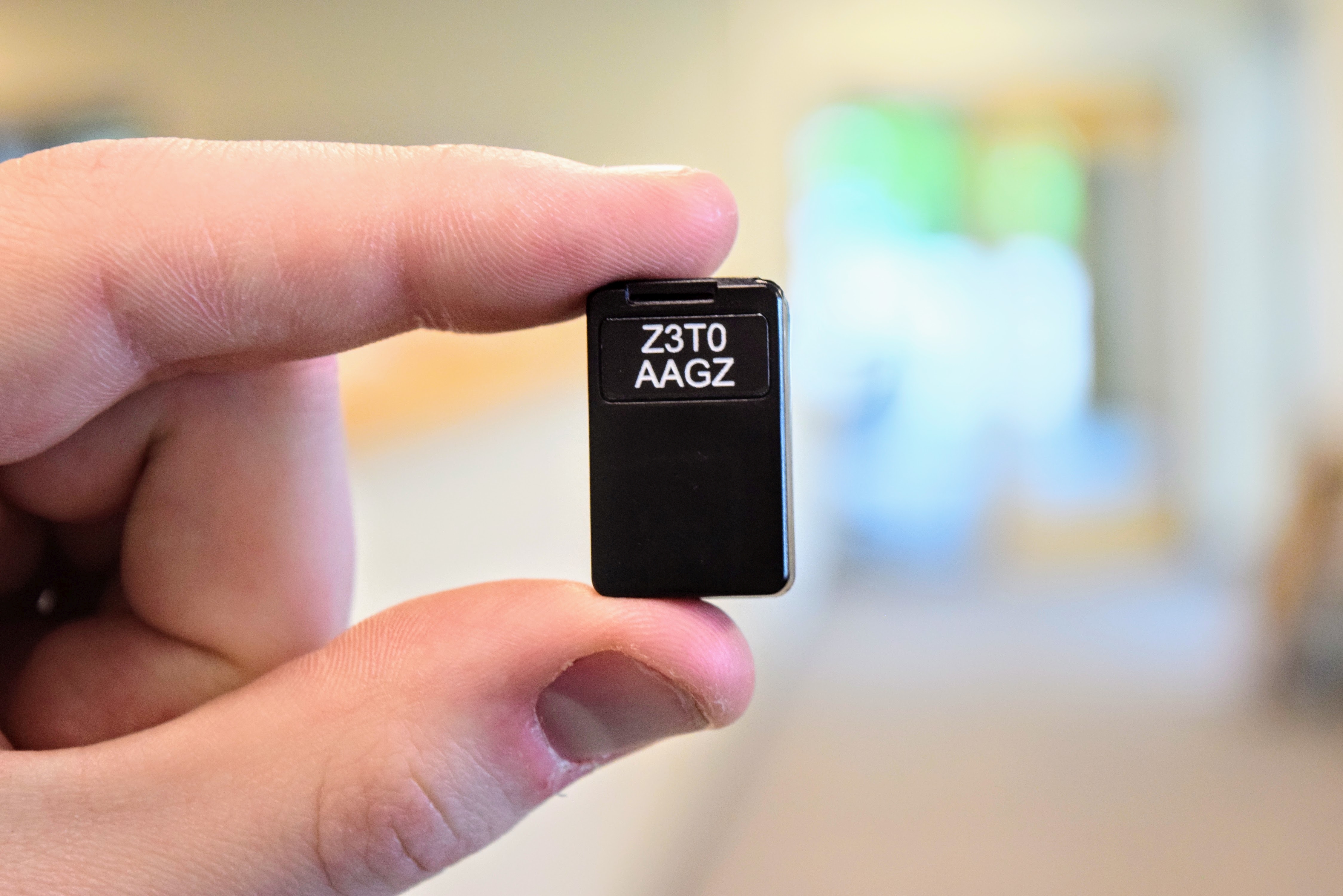 QZFM Gen-3 sensor held between two fingers