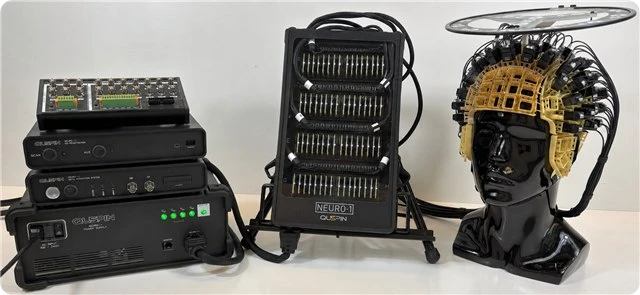 The complete Neuro-1 system: DAQ, co-registration unit, power supply, backpack, and sensor helmet on a mannequin head
