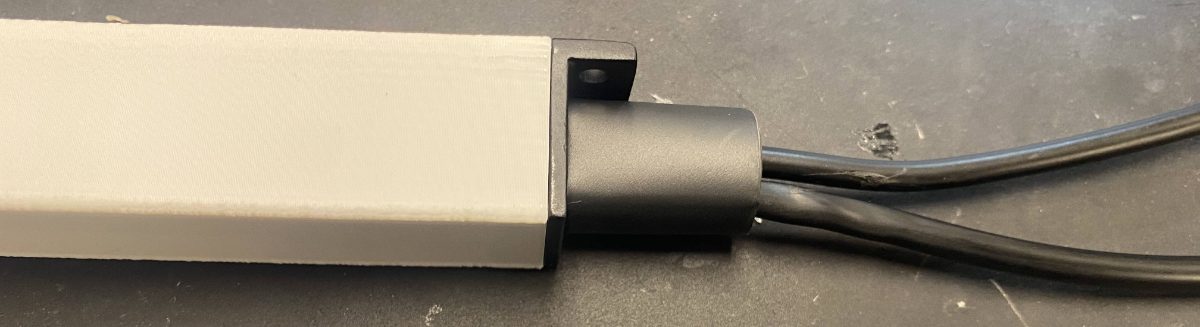 Heat-shrink tubing slid over the input cables against the sled