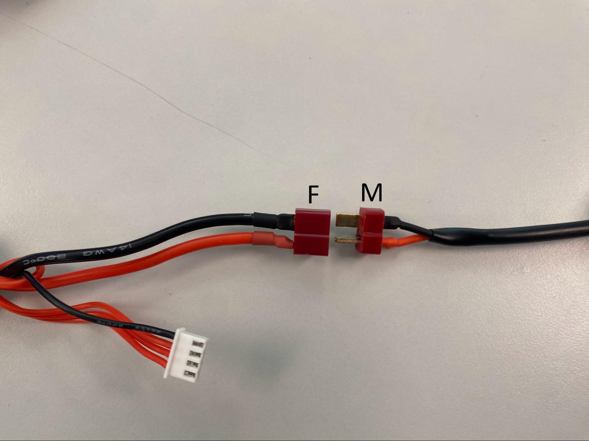 Battery adapter connectors, disconnected, showing the female (F) and male (M) ends